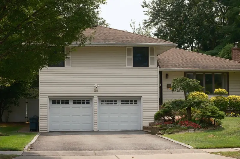 Two-story house with a double garage and landscaped front yard